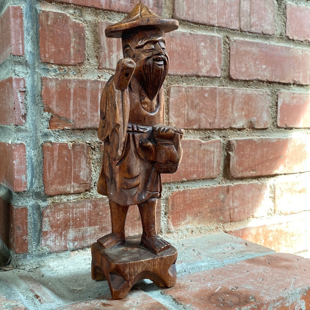 Wooden happy bearded Asian man sculpture